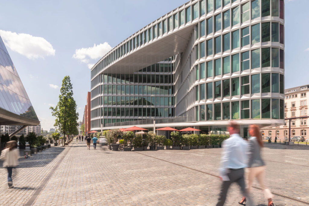 Blick auf das Westhafen Haus mit Außenbereich des Restaurants L'Osteria