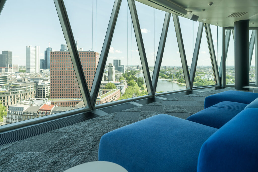 Büro mit Couch im Westhafen Tower mit Blick auf die Skyline von Frankfurt am Main