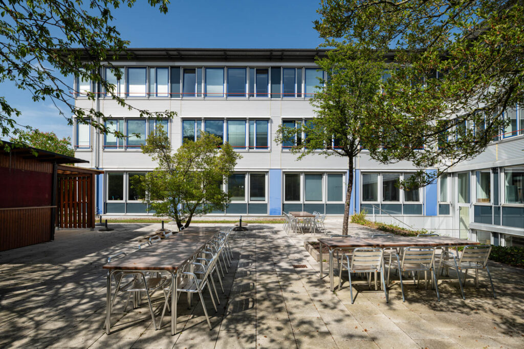 Außenbereich mit Tischen und Stühlen am Bürohaus Haar in München